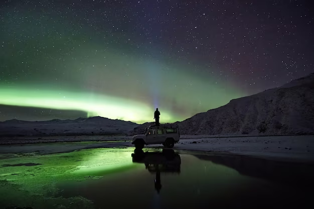 Aurora Borealis over snowy mountains - the perfect spot to witness the Northern Lights